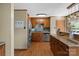 Well maintained kitchen features granite countertops, wood cabinets and backsplash, and stainless steel appliances at 139 Fort Dobbs Rd, Statesville, NC 28625