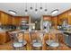 Eat-in kitchen featuring a large island with bar seating and modern lighting fixtures at 139 Fort Dobbs Rd, Statesville, NC 28625