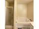 This bathroom features a bathtub and stand up shower at 14022 Drake Watch Ln, Charlotte, NC 28262