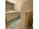 Bright bathroom vanity featuring a wide mirror, white cabinets, and a light blue rug on tile flooring at 14022 Drake Watch Ln, Charlotte, NC 28262