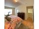 Bedroom with a Peloton bike near the window, dresser, and king bed at 14022 Drake Watch Ln, Charlotte, NC 28262