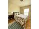 Cozy bedroom with hardwood floors, a bed with floral bedding, and natural light from a window at 14022 Drake Watch Ln, Charlotte, NC 28262