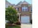 Charming brick townhome featuring a well-maintained lawn and an attached one-car garage at 14022 Drake Watch Ln, Charlotte, NC 28262