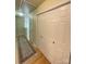 Hallway with closet storage and a rug runner on hardwood floors at 14022 Drake Watch Ln, Charlotte, NC 28262