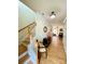Inviting foyer featuring hardwood floors, stairs, elegant decor, and views into the living area at 14022 Drake Watch Ln, Charlotte, NC 28262