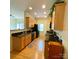 Spacious kitchen equipped with wooden cabinets, sleek granite countertops, and modern black appliances at 14022 Drake Watch Ln, Charlotte, NC 28262