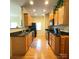 Efficient kitchen features stainless appliances, wood cabinets, and sleek black granite countertops at 14022 Drake Watch Ln, Charlotte, NC 28262