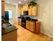Well-lit kitchen featuring wood cabinets, granite countertops, and modern appliances for cooking needs at 14022 Drake Watch Ln, Charlotte, NC 28262