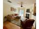 Cozy living room featuring hardwood floors, fireplace, a ceiling fan, and sliding glass doors to patio at 14022 Drake Watch Ln, Charlotte, NC 28262
