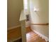 Staircase with wood handrail, white trim, and a window at the top landing at 14022 Drake Watch Ln, Charlotte, NC 28262
