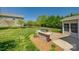 Lovely backyard featuring a stone barbecue area, expansive lawn, and mature landscaping at 14905 Skyscape Dr, Huntersville, NC 28078