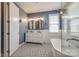 Elegant bathroom with double vanity, tile floors, subway tile, soaking tub, and a modern light fixture at 14905 Skyscape Dr, Huntersville, NC 28078