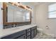 The renovated bathroom features a double sink vanity with a framed mirror and decorative tile floor at 14905 Skyscape Dr, Huntersville, NC 28078