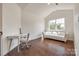 A bedroom features a desk, chair, daybed, hard wood floors, and a window with views at 14905 Skyscape Dr, Huntersville, NC 28078