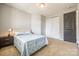A bedroom with a queen-sized bed, gray walls, neutral carpet, and a closet with doors at 14905 Skyscape Dr, Huntersville, NC 28078