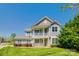 Charming two-story home boasts a welcoming front porch and balcony, nestled on a well-manicured lawn at 14905 Skyscape Dr, Huntersville, NC 28078