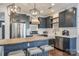 This kitchen features gray cabinetry, a butcher block island with bar stool seating, and stainless steel appliances at 14905 Skyscape Dr, Huntersville, NC 28078