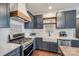 The spacious kitchen has stainless steel appliances and a farm sink with white subway tile backsplash at 14905 Skyscape Dr, Huntersville, NC 28078