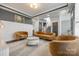 Well-lit living room features stylish furniture, modern design, and neutral décor at 14905 Skyscape Dr, Huntersville, NC 28078