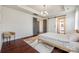 Spacious bedroom featuring hardwood floors, neutral walls, and sliding barn doors leading to the bathroom at 14905 Skyscape Dr, Huntersville, NC 28078