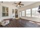 Bright sunroom with lots of windows, tile flooring and door leading to kitchen with barstool seating at 14905 Skyscape Dr, Huntersville, NC 28078