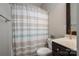 A full bathroom featuring a shower with a striped curtain, toilet and dark wood vanity at 2001 Cramer Place Ct, Cramerton, NC 28032