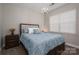 Bedroom with a chandelier, window and a bed with drawer storage adding functionality to the room at 2001 Cramer Place Ct, Cramerton, NC 28032