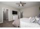 Comfortable bedroom with a ceiling fan, neutral walls, and view of an open door leading into a tiled bathroom at 2001 Cramer Place Ct, Cramerton, NC 28032