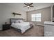 Cozy bedroom featuring a queen-size bed, carpeted floors, ceiling fan, and natural light from the window at 2001 Cramer Place Ct, Cramerton, NC 28032