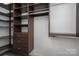 Well-organized walk-in closet with custom shelving and drawers for maximum storage capacity and convenience at 2001 Cramer Place Ct, Cramerton, NC 28032