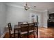Well-lit dining area featuring hardwood floors, a wooden table, and modern chandelier at 2001 Cramer Place Ct, Cramerton, NC 28032