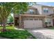 Charming townhome featuring a stone facade, two-car garage, and beautifully landscaped front yard at 2001 Cramer Place Ct, Cramerton, NC 28032