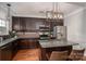 Modern kitchen with dark cabinets, granite countertops, stainless steel appliances, and hardwood floors at 2001 Cramer Place Ct, Cramerton, NC 28032