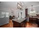 Open kitchen with granite island, dark cabinets, stainless appliances, and hardwood floors at 2001 Cramer Place Ct, Cramerton, NC 28032