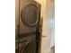 Modern laundry room featuring a stacked washer and dryer, ensuring efficient use of space at 2001 Cramer Place Ct, Cramerton, NC 28032