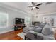 Cozy living room featuring hardwood floors, a gray sectional sofa, and lots of natural light at 2001 Cramer Place Ct, Cramerton, NC 28032