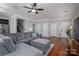 Comfortable living room with hardwood floors, gray sectional sofa, and easy access to other rooms at 2001 Cramer Place Ct, Cramerton, NC 28032