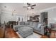 Spacious living room with hardwood floors, a gray sectional sofa, and an open floor plan at 2001 Cramer Place Ct, Cramerton, NC 28032