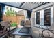 Outdoor patio features a pergola with black drapes, comfortable seating, and a fire pit table at 2001 Cramer Place Ct, Cramerton, NC 28032