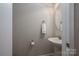 Neat powder room with a pedestal sink, round mirror, and neutral color scheme for a minimalist look at 2001 Cramer Place Ct, Cramerton, NC 28032
