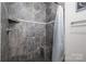 Tiled shower with a built-in corner seat and a mosaic-trimmed accent line adding a touch of elegance at 2001 Cramer Place Ct, Cramerton, NC 28032