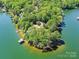 A stunning aerial view of a private peninsula with lush greenery, waterfront homes and docks at 2045 Manila Bay Ln, Tega Cay, SC 29708