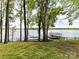 Lush backyard with shade trees, waterfront views, and a cozy hammock at 2045 Manila Bay Ln, Tega Cay, SC 29708