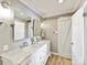Neutral bathroom with a sliding barn door and double sink at 2045 Manila Bay Ln, Tega Cay, SC 29708