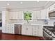 Bright kitchen with stainless steel appliances and white cabinets at 2045 Manila Bay Ln, Tega Cay, SC 29708