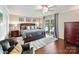 Serene main bedroom with a king-sized bed, hardwood floors, and access to a balcony, offering a tranquil retreat at 2045 Manila Bay Ln, Tega Cay, SC 29708
