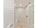 Luxurious walk-in shower featuring marble tile, a built-in bench, and modern fixtures, providing a spa-like experience at 2045 Manila Bay Ln, Tega Cay, SC 29708