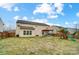 Spacious backyard with a wooden playground set, patio area, and privacy fence—great for outdoor entertaining at 2065 Taney Way, Indian Land, SC 29707