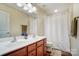 Bathroom with a double sink vanity, brown cabinets, and a white shower curtain at 2065 Taney Way, Indian Land, SC 29707