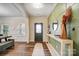 Inviting foyer with hardwood floors, console table, and accent wall at 2065 Taney Way, Indian Land, SC 29707